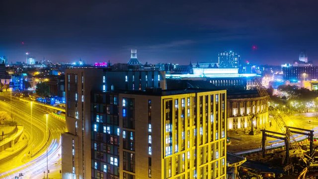 Liverpool, UK. Time-lapse of aerial view of night traffic in the center of Liverpool, England, UK with dark sky and illuminated buildings.