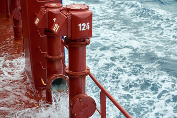 View of Ballast Water exchange process onboard of a ship using flow-through method underway in open ocean. Overflow method through ballast tank air head.