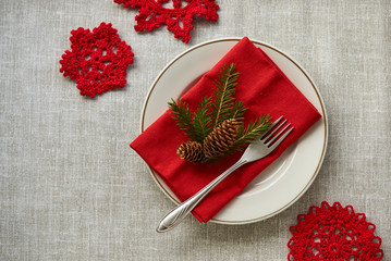 New year table setting with fir branch and pine cone