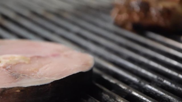Close Up Grilling a Filet of  Swordfish Involved in Smoke.