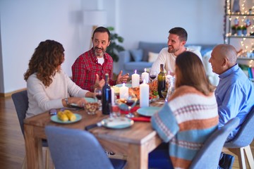 Beautiful family smiling happy and confident. Eating roasted turkey celebrating Christmas at home