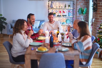 Beautiful family smiling happy and confident. Eating roasted turkey celebrating Christmas at home