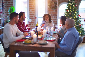 Beautiful family smiling happy and confident. Eating roasted turkey celebrating Christmas at home