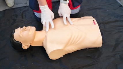 Medical specialist shows the correct position of the hand when performing a cardiopulmonary...