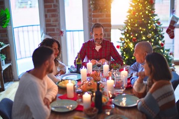 Beautiful family smiling happy and confident. Eating roasted turkey celebrating Christmas at home