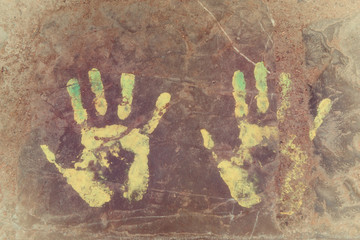 Handprints (left and right hand) on concrete floor.