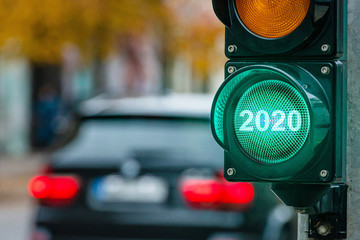 A city crossing with a semaphore. Green light with text 2020 in semaphore. New Year concept.