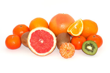Assortment of whole and sliced exotic fruit on a white background. Kiwi and Mandarin Orange Slices