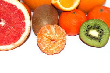 Assortment of sliced exotic fruit close up on a white background. Kiwi and Mandarin Orange Slices