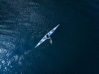 Blue kayak with man sea, open space, aerial top view