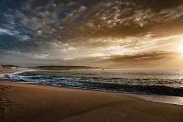 Fototapeta na wymiar Evening time by Atlantic ocean in Nazare, Portugal.