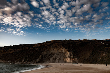 Evening time by Atlantic ocean in Nazare, Portugal.