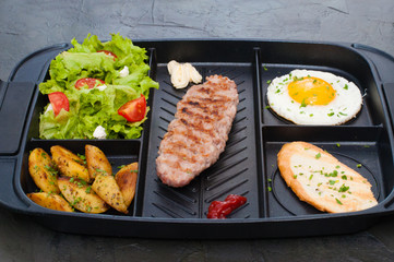 Breakfast, cutlet or steak, tomato salad, fried potato, crouton and fried egg