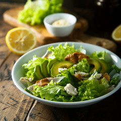 Homemade Caesar salad with chicken and avocado