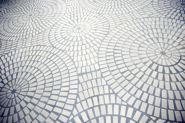 Full frame background of concentric circles of white bricks set in dark gray mortar