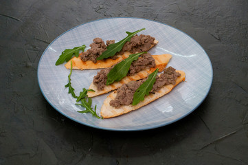 Croutons with paste and arugula. Festive appetizer, New Year's Italian dish