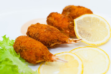 Crab claws fried in batter with lemon, lettuce and tasty sweet and sour sauce