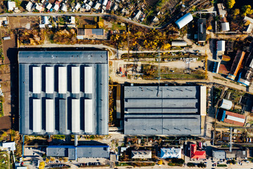 Large modern factory building. Machine building production site, top view on facility, aerial view, open space.
