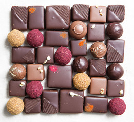 Chocolate candy making. Handmade candy. Sweets from dried fruits and nuts.