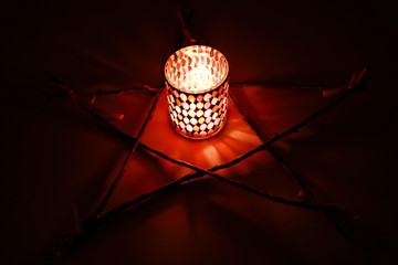 the pentagram, the fire in the candle holder and figurines for ritual magic