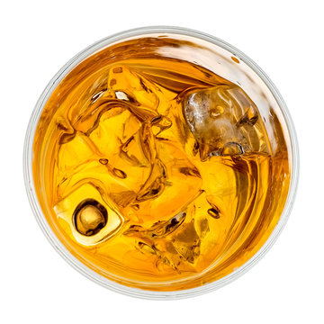 Whiskey glass with ice cubes, top view