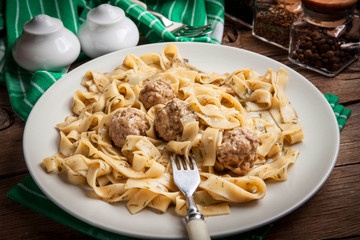Tagliatelle pasta with beef meatballs.