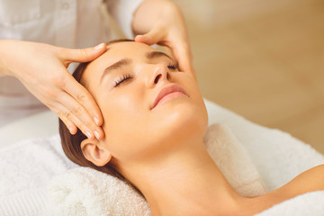 Beautiful woman has a facial massage in a beauty clinic.