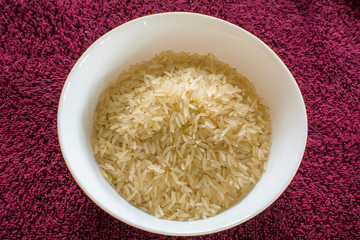 White rice on a ceramic plate, rice grains that have undergone a complete cleaning and grinding cycle without a bran shell are considered white