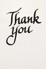 Thank you message handwritten in fresh black ink on textured white paper