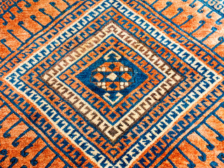 Square geometric pattern of oriental persian carpet in mainly red and blue
