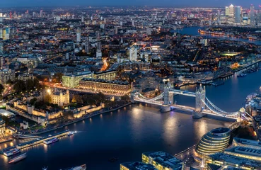 Poster Blick auf die beleuchtete Skyline von London am Abend mit Tower Bridge und modernen Bürogebäuden entlang der Themse © moofushi