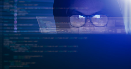 Hacking and internet crime concept, hacker using computer coding on digital interface.