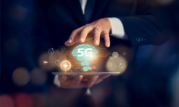 Concept of future technology 5G network, businessman hands holding tablet and high-speed new generation networks screen interface. Wireless systems and internet of things (IOT).