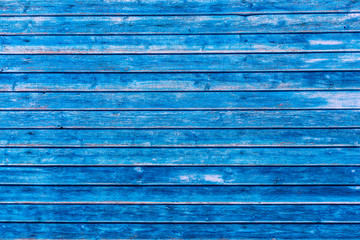 Blue wooden texture background. Wall surface. Horizontal wooden boards. Close up with copy space. Old grungy wooden planks background in blue color. Abstract background and texture for design.