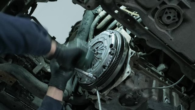 Change and repair clutch, drive axle. working underneath a lifted car