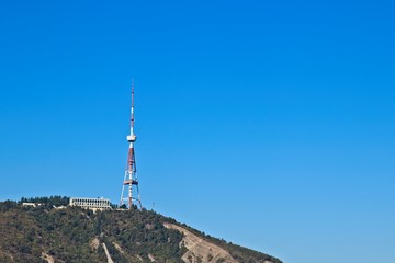 Obraz premium Television broadcasting tower on Mtatsminda Hill in Tbilisi, Georgia. This is a popular tourist attraction in the city. 