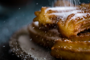 Typical churros with sugar and hot chocolate in a autumn morning