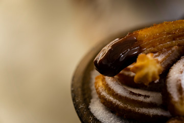Typical churros with sugar and hot chocolate in a autumn morning