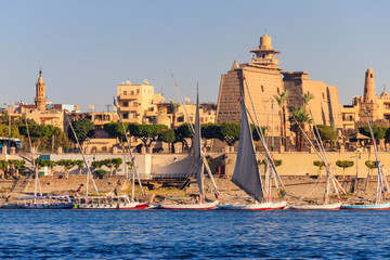 Luxor Temple is a large Ancient Egyptian temple complex on east bank of Nile river in Luxor (ancient Thebes). View from Nile river - obrazy, fototapety, plakaty