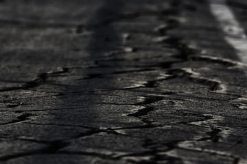 asphalt in cracks texture / abstract background cracks on asphalt road