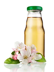 Small apple juice bottle with apple blossoms, close up