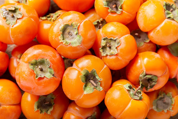 fresh ripe persimmon fruit as background