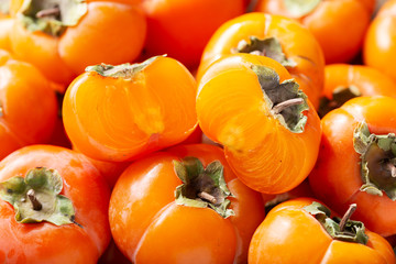fresh ripe persimmon fruit as background