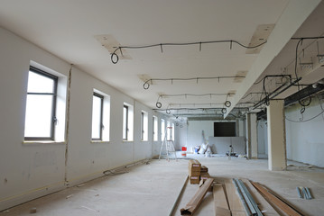 Improvement construction work in huge white office.