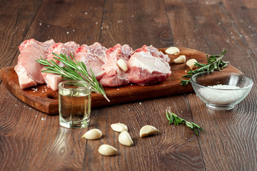 Fresh steak loin of raw meat and spices and a knife lies on a wooden background. copy space