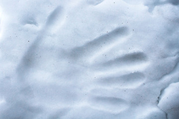 Imprint palm person on the snow surface