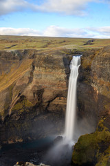 Panorama of colorful gorge with four waterfalls Haifoss, the fourth highest waterfall(122m) of the island, and Granni. The viewpoint on the sheer cliffs at the edge of canyon..