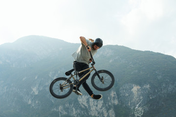 Fototapeta na wymiar Bmx rider is making extreme stunts.