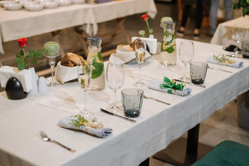 Served table at the restaurant with different decorations on the table. Preparing to celebration