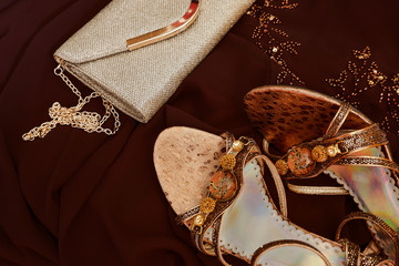 Fashion flat lay. Formal evening wear: brown dress, golden chain bag, high heels